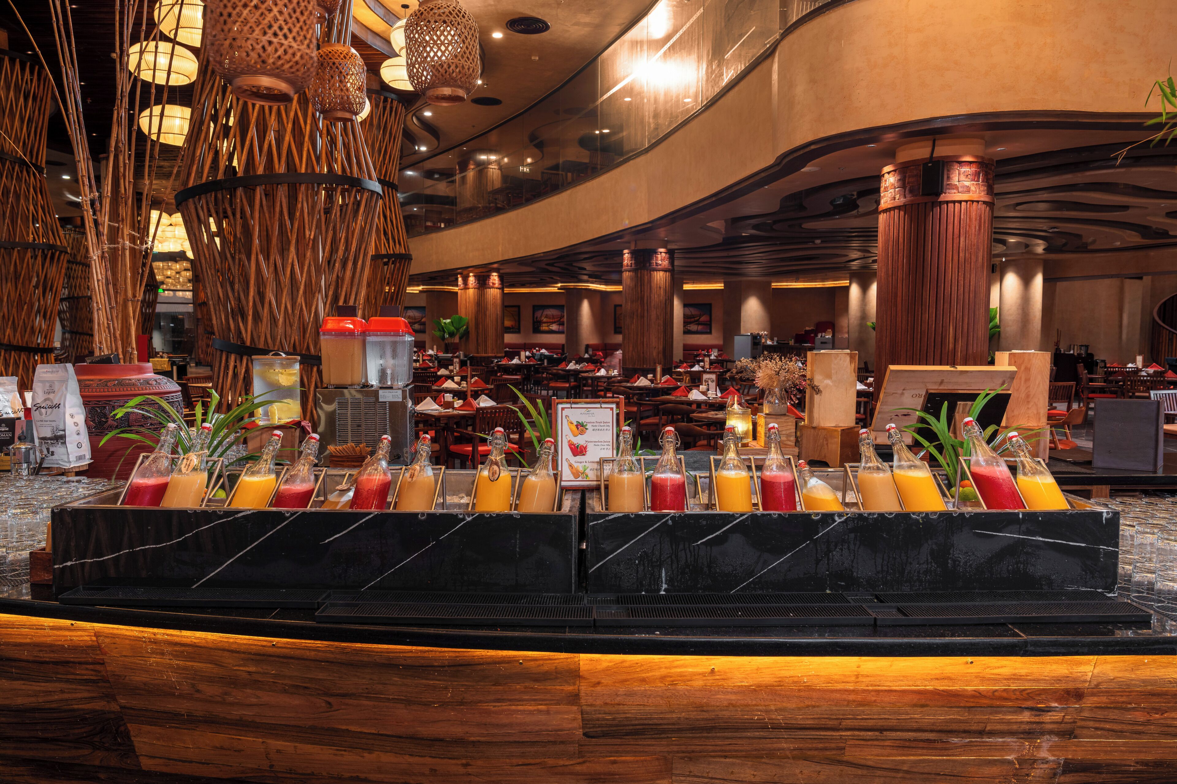A buffet area with a variety of beverages, a wooden counter, and a modern interior design.
