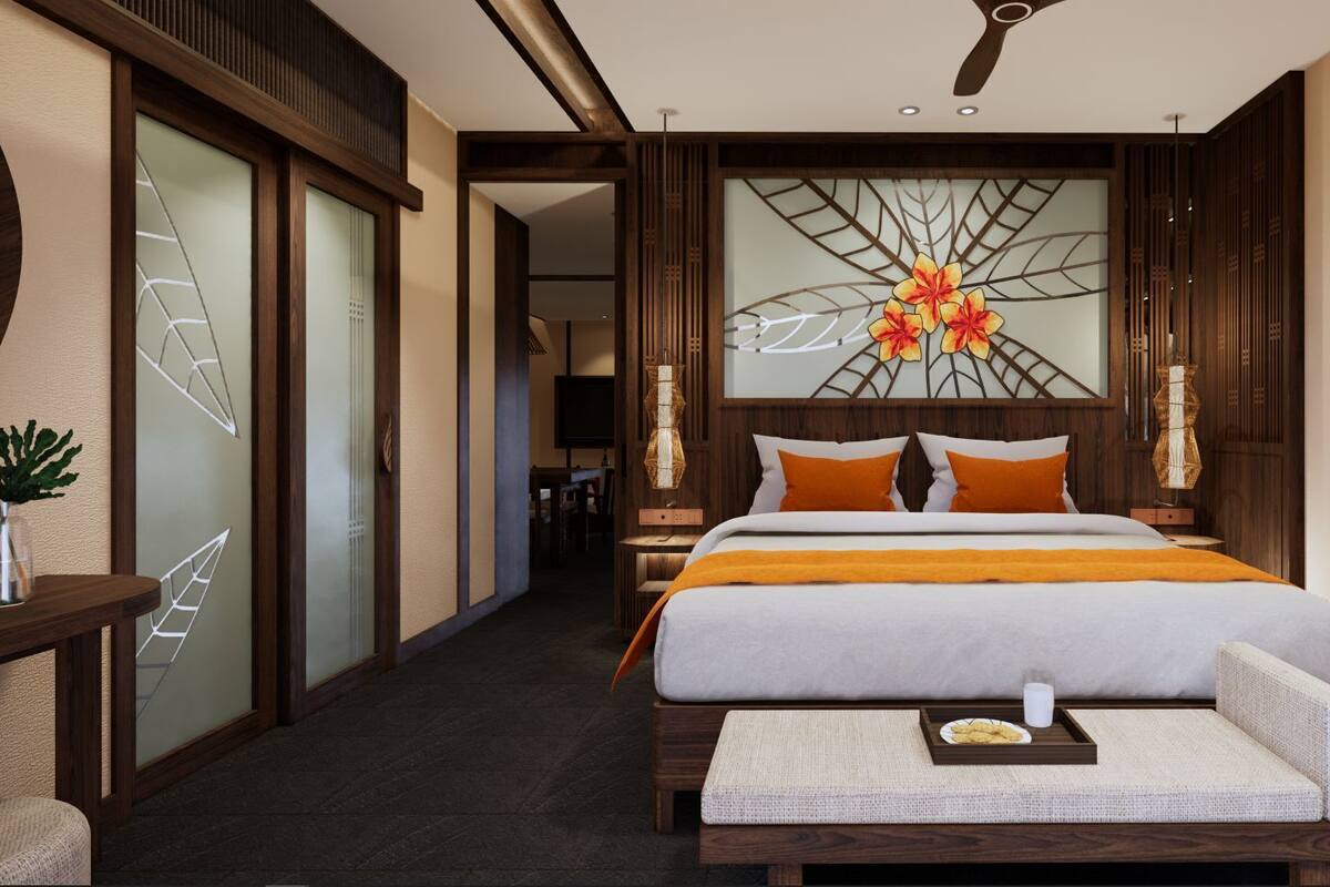A hotel room with a bed, bedside table, and a decorative wall piece.