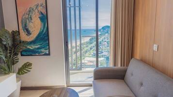 Family Apartment, Balcony, Sea View | Living area | 55-inch Smart TV with cable channels, pay films, smart speakers