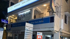 A building with signage for 'New Cars India SK Motors' and 'Bosch Car Service'. - GSR Stay Home (Puducherry)