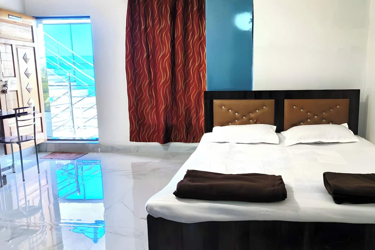 A hotel room with a bed, a window, and a view of the outside.