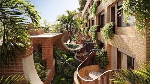 A multi-level building with brick walls, curved balconies, and lush greenery. - The EVE Hotel Sydney (Redfern)