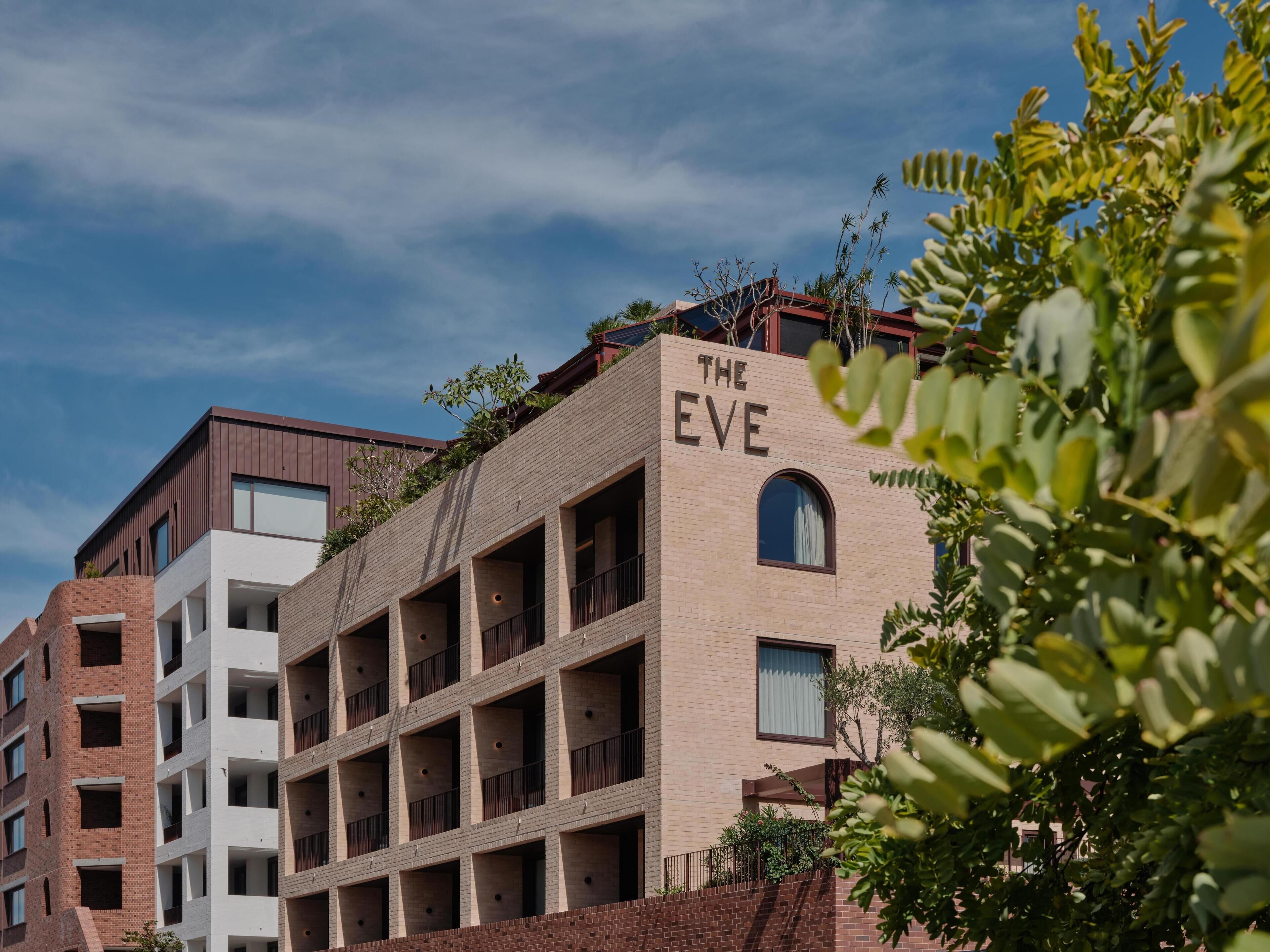 A multi-story building with a sign reading "THE EVE" on the facade.