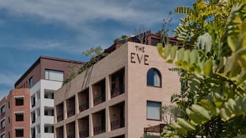 A multi-story building with a sign reading "THE EVE" on the facade.