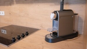 A kitchen with a built-in stove and a coffee maker. - Hochkönig 4 Apartment (Embach)