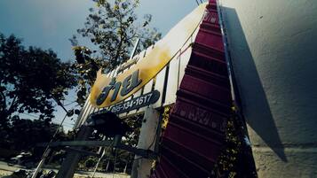 A building with a sign that reads "The Hard Rock Cafe" and a phone number.