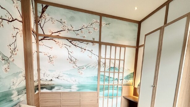 A bedroom with a large bed, a wooden wardrobe, and a view of cherry blossoms through a shoji screen. - Mice House (Cam Ly - Da Lat)