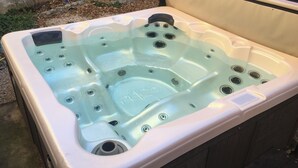 A hot tub with a built-in seat, multiple jets, and a control panel. - In the Luberon, indulge yourself with a private spa and sauna (Reillanne)