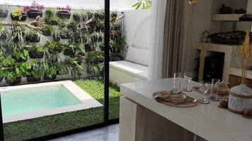 Deluxe Villa, Pool View | Living area | TV