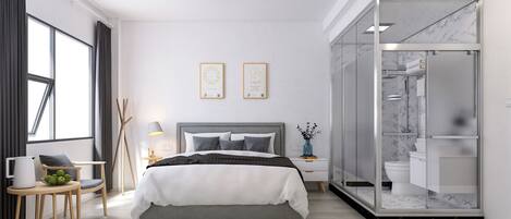 A modern bedroom with a large bed, a bedside table, a chair, a lamp, and a view of the bathroom.