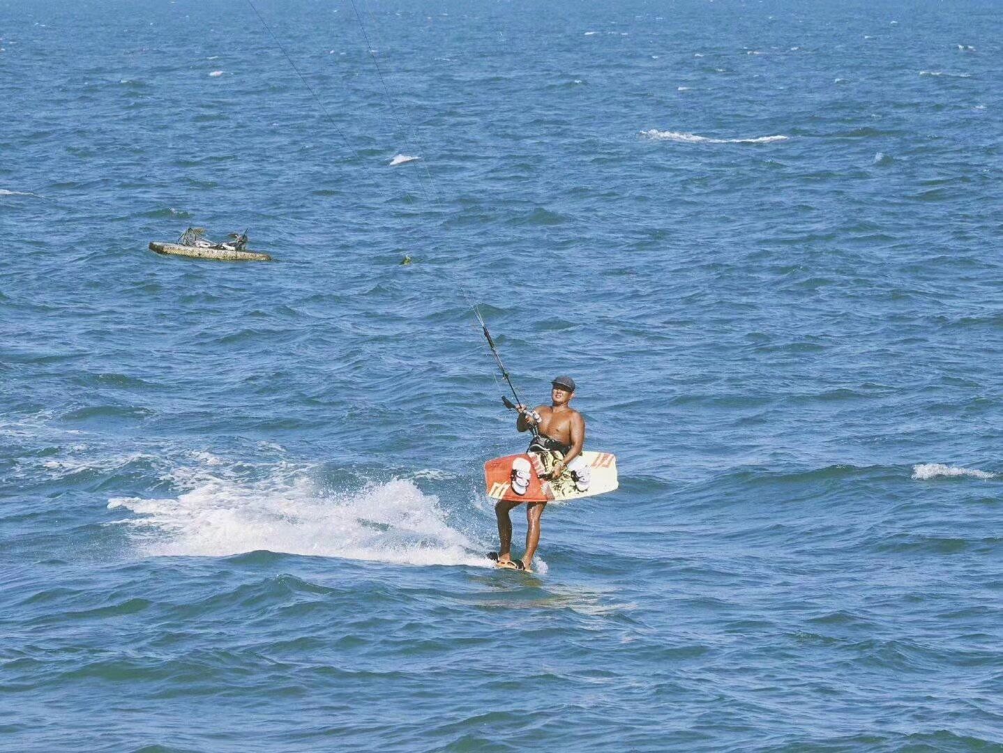 A person windsurfing on a body of water.