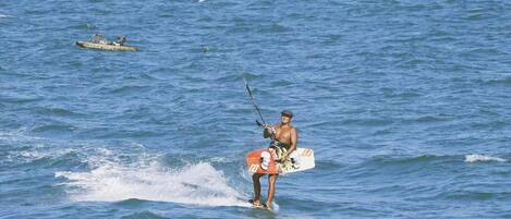 A person windsurfing on a body of water.