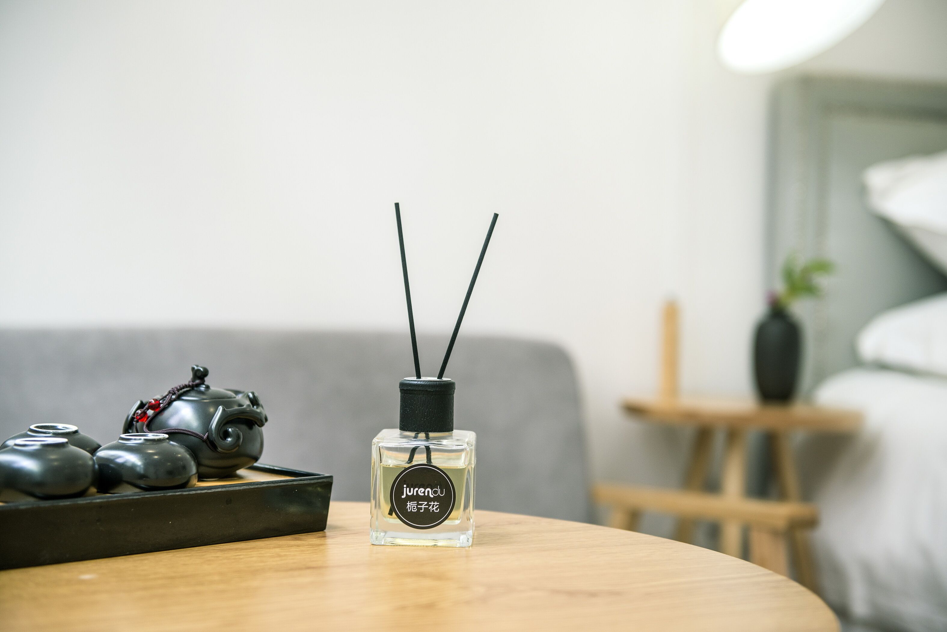 A table with a bottle of Jurendu cologne and a tray of teapots.
