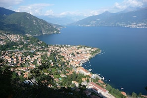 A coastal town with a marina, surrounded by mountains and a large body of water.