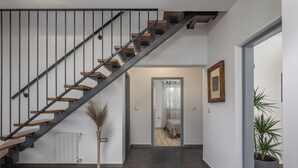 A modern interior with a staircase, a radiator, a potted plant, and a framed picture on the wall. - 4 BDR Villa Filleona With Pool (Labin)