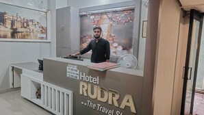 A hotel reception desk with a sign reading "Hotel Rudra - The Travel Store." - Rudra Hotel (Varanasi)