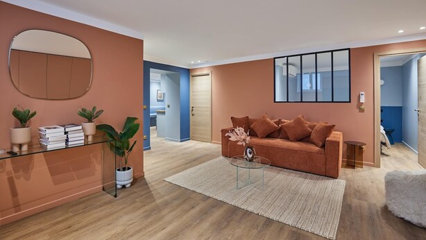 A modern living room with a sofa, coffee table, and a glass side table. There is a mirror on the wall and a door leading to another room. - Superb AC Apartment Center of Paris (Paris)