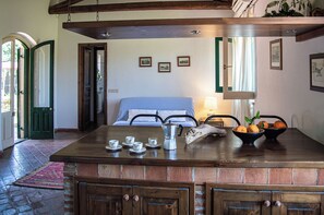 Cozy retreat with a wooden dining table, comfortable bed, and traditional decor.