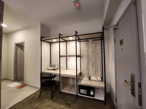 A compact room with a desk, chair, and a small storage unit. - Perkasa Hotel Mt Kinabalu (Ranau)
