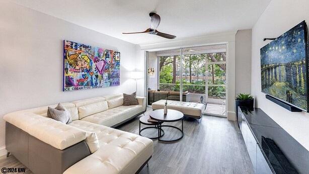 A modern living room with a white sofa, a round coffee table, and artwork on the walls. - NAPLES 2B/2B IMPERIAL CONDO W/ STYLE & LAKE VIEWS! POOLS! NEAR EVERYTHING! 102 (Naples)