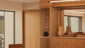 A modern interior with a wooden cabinet, a bench, and a large mirror.