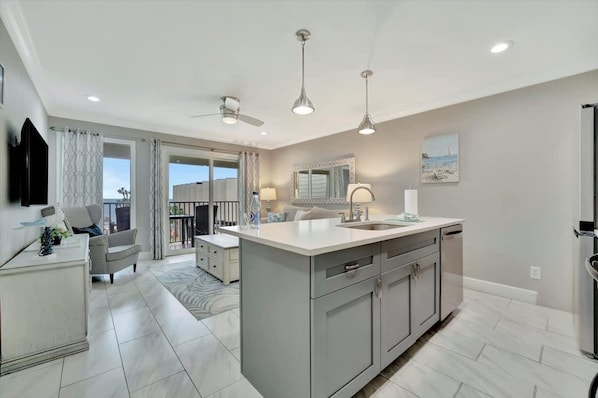 A modern kitchen with a central island, built-in cabinets, and a large window. - Pearl Suite a Balcony Bayview Suite Htd Pool (Tampa)