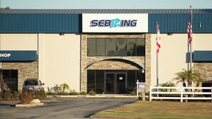 A commercial building with a sign reading "SEBIZING" and a "SHOP" sign on the left.