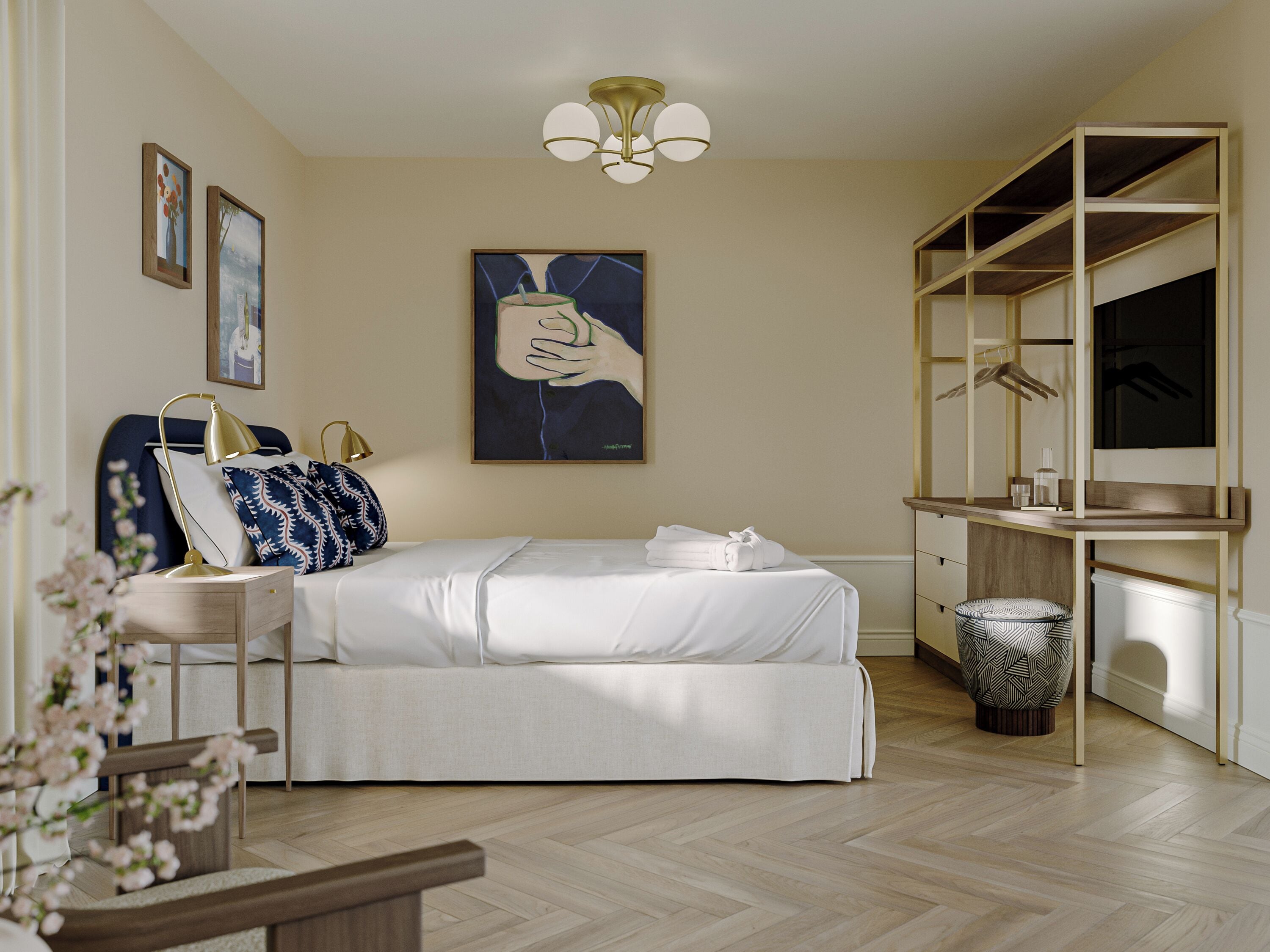 A modern bedroom with a bed, bedside table, lamp, artwork, and a wardrobe.