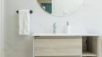 Shower, hair dryer, towels, toilet paper