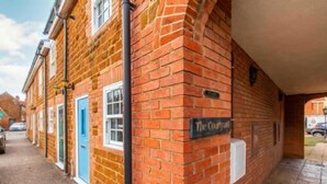 A brick building with a sign that reads 'The Courtyard.'