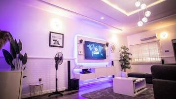 Deluxe Apartment, Balcony, City View | Living area | Flat-screen TV