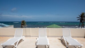 Three white sun loungers on a balcony with a view of the ocean. - Serene Barbados escape with ocean view - Peaceful (Christ Church)