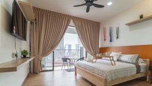 A modern bedroom with a bed, a TV, a balcony, and a city view. - [NEW] Private Jacuzzi | Near Velocity Mall | MRT | Retro Games (Cheras)
