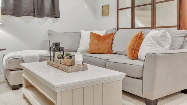 A modern living room with a grey sofa, a white coffee table, and a grey armchair. - Mountain Views , Skiing, Lake & Coffee Bar (Ogden)