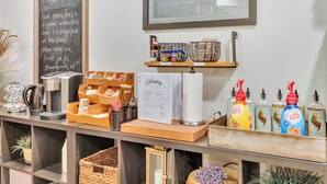 A reception desk with a chalkboard, a framed architectural drawing, and a coffee station. - Mountain Views , Skiing, Lake & Coffee Bar (Ogden)