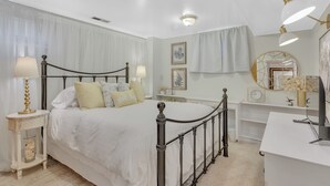 A bedroom with a bed, bedside tables, a dresser, and a vanity with a mirror. - Mountain Views , Skiing, Lake & Coffee Bar (Ogden)