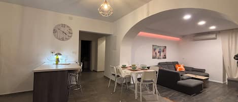 Apartment, City View | Living area | 32-inch flat-screen TV with cable channels