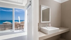 A modern bathroom with a large window, a white sink, and a mirror. - RAFFAELLO BEACH (Rhodes)