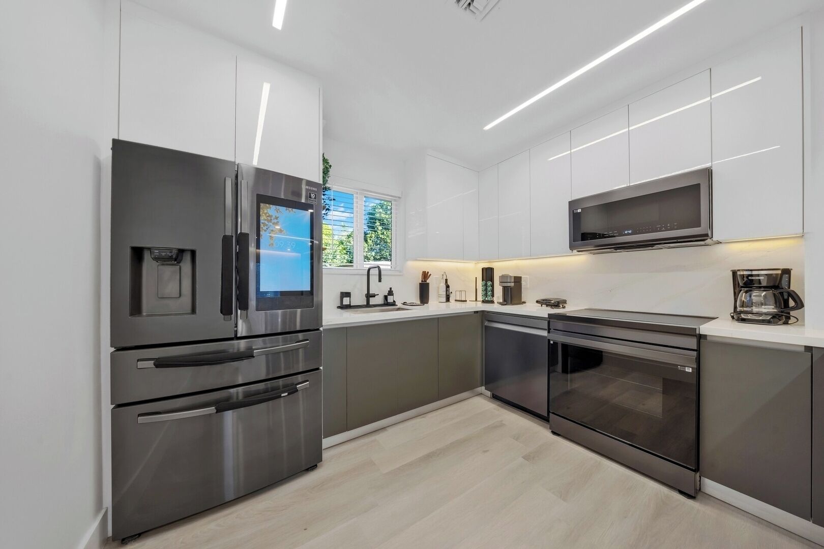 A modern kitchen with stainless steel appliances, a built-in oven, and a microwave.