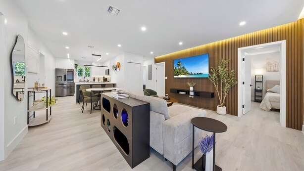 A modern living space with a kitchen, dining area, and a cozy seating area. - New Design Dist Gem:Pool,HotTub,Minigolf,Nespresso (Miami)
