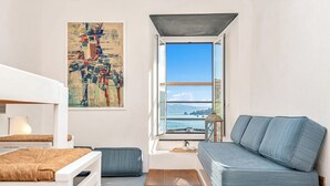 A modern room with a sofa, a small table, a lamp, and a painting. - Neverland, Terre Marine (Portovenere)