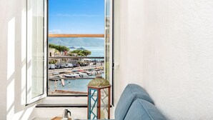 A balcony with a view of a marina, boats, and a distant mountain. - Neverland, Terre Marine (Portovenere)