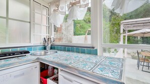 A kitchen with a large window, a dishwasher, and a sink. - The Chalet by the Sea, Terre Marine (Vernazza)