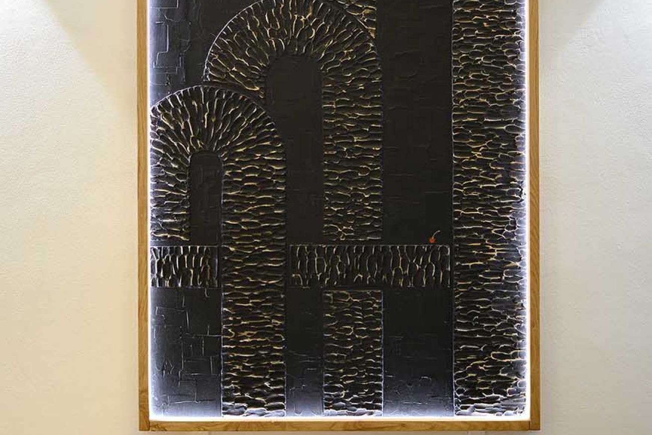 A framed abstract art piece with geometric shapes and patterns.
