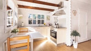 A bright kitchen with wooden beams, a white countertop, and a small dining table with chairs. - Home2Book Comfy Cottage Hibiscus, Peace Retreat (La Orotava)