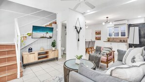A modern living room with a staircase, a dining area, and a kitchen. - Villa Verde 1#8 (Tamarindo)