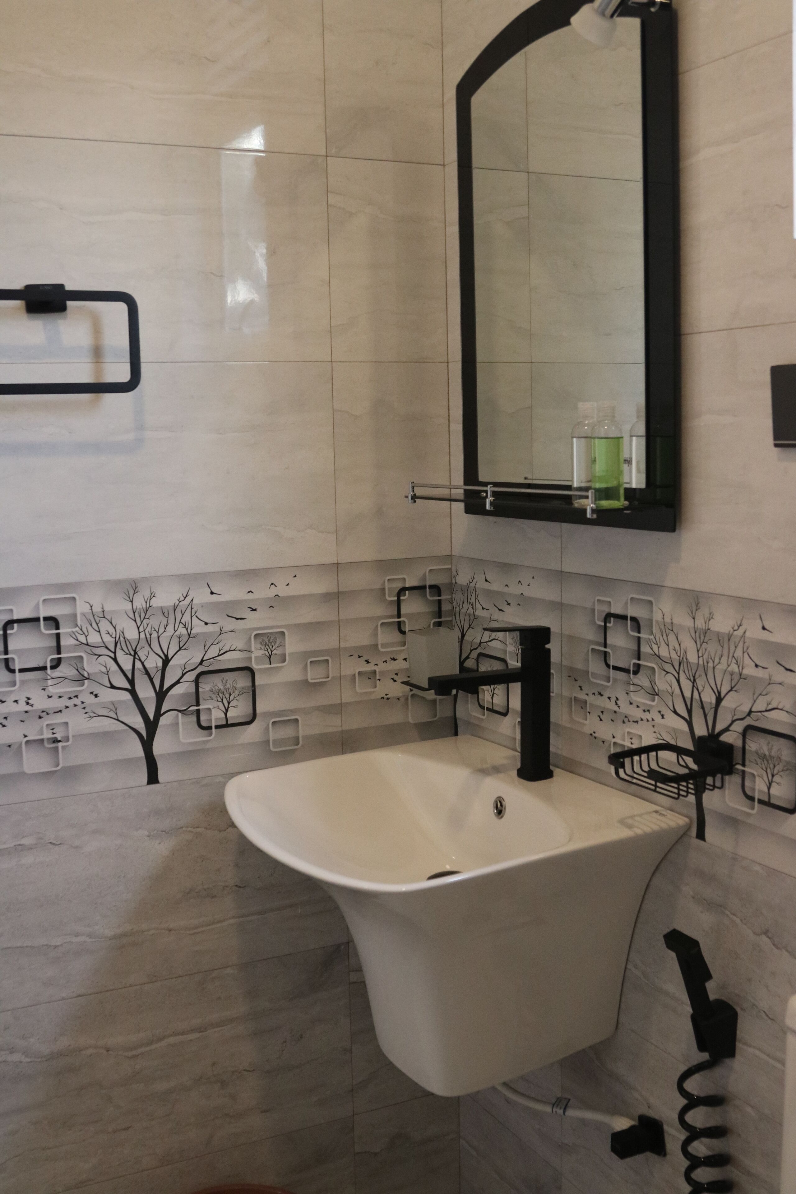 A modern bathroom with a freestanding sink, a mirror, and a towel rack.