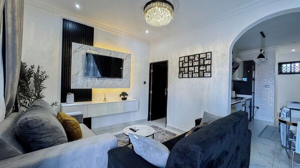 Living area - Chic 1-bedroom apartment with AC and WiFi in vibrant Accra. (Tema)