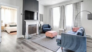 A modern living room with a fireplace, a television, and a sofa.