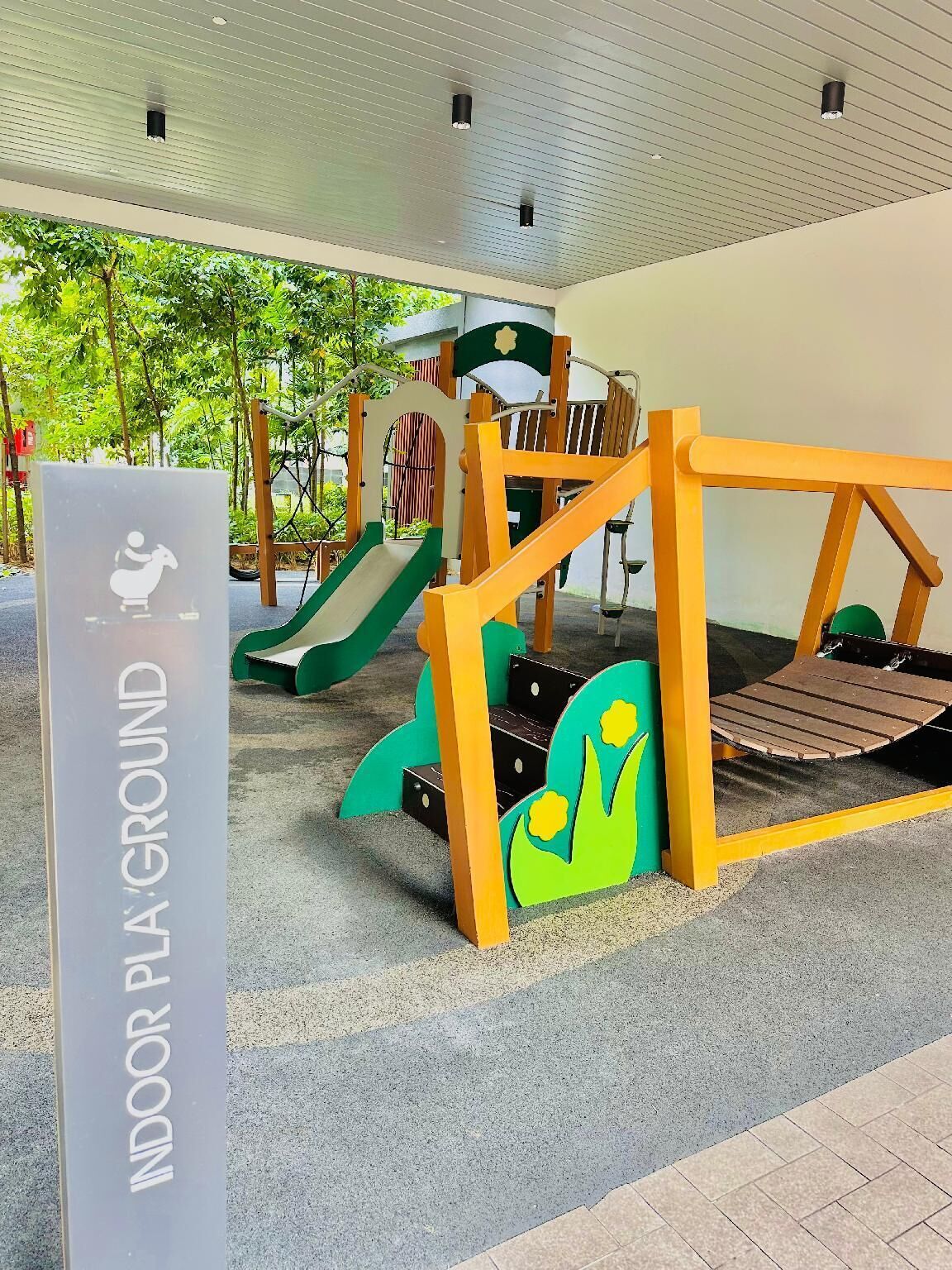 An indoor playground with a slide, climbing structures, and a play area.